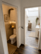 Blick Bad WC - (KI - generiert) - Charmante Dachgeschosswohnung mit Balkon nahe Wallersee